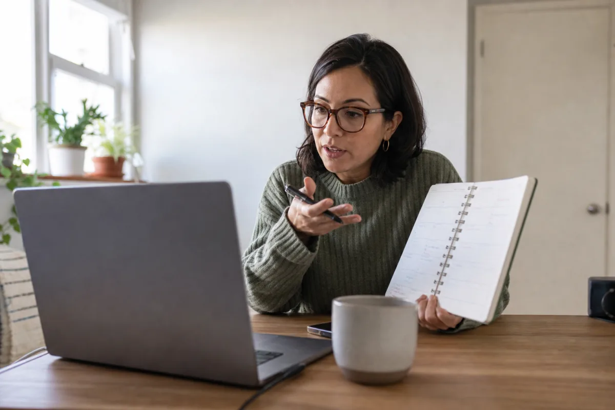 A home worker discussing a new assignment while checking their workload